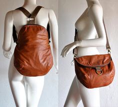 a mannequin holding a brown purse on it's back and the other side