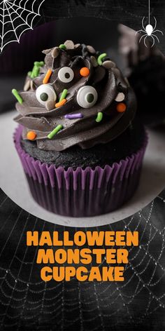 a halloween cupcake with chocolate frosting and sprinkles on top, sitting in front of a spider web