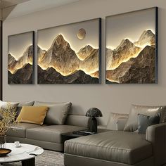 three paintings on the wall in a living room