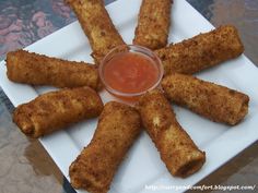 some food is on a white plate with dipping sauce