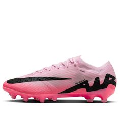 a pink and black soccer shoe with white lettering on the bottom, in front of a white background