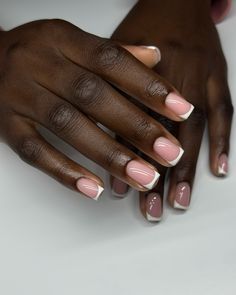 a woman's hands with pink and white french manies