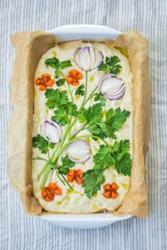 an entree with onions, celery and carrots in a white dish