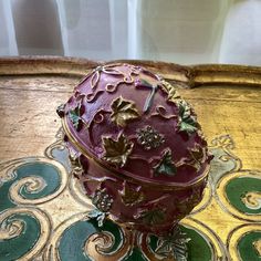 an ornately decorated box sitting on top of a table