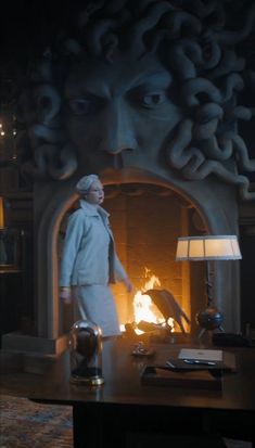 a person standing in front of a fireplace