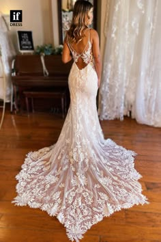 a woman standing in front of a piano wearing a wedding dress with an open back