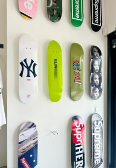 several skateboards mounted to the side of a wall in a room with white walls