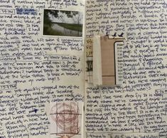 an open notebook with writing on it and pictures hanging from the pages in front of them