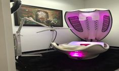 a futuristic toilet with pink lights on it's seat