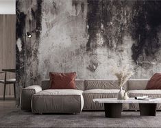 a living room with couches and tables in front of a wall covered in peeling paint