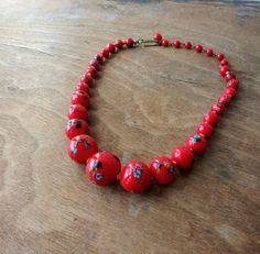 "Vintage glass bead necklace/choker, glass beads are descending in size and are hand knotted between each. Each bead has colorful striped \"balls\" on them that look like little sea urchins. Circa 1940's - 50's (possibly earlier), marked Japan on hook clasp. Largest bead is approx. 3/4\". Necklace is in good condition, please see photos. Offbeat Avenue uses recycled packaging when available." Vintage Beads For Jewelry Making, Adjustable Vintage Beads For Jewelry Making, Retro Single Strand Necklaces With Round Beads, Vintage Beaded Necklaces With Round Beads For Gift, Vintage Adjustable Beaded Necklace With Polished Beads, Retro Adjustable Beaded Necklaces With Round Beads, Retro Single Strand Necklace With Round Beads, Vintage Adjustable Necklaces With Colorful Beads, Vintage Single Strand Beads For Jewelry Making