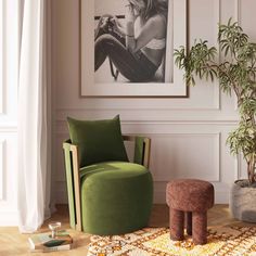 a living room with a green chair and footstool in front of a painting on the wall