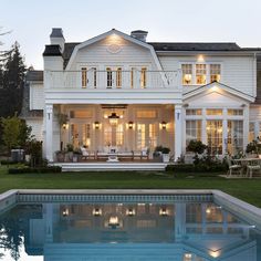 a large white house sitting next to a swimming pool