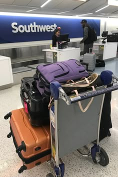 luggage sitting on top of a cart in an airport