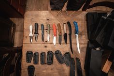 many different types of knives on a wooden table