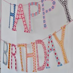 a happy birthday banner hanging on a wall