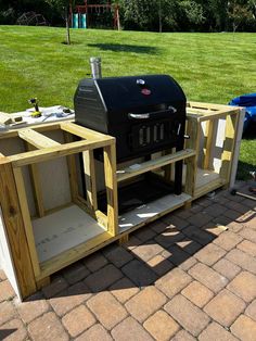 an outdoor bbq grill built into the ground