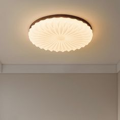 the ceiling light is dimmed and has a circular design on it's surface