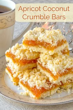 three pieces of apricot coconut crumble bars on a plate next to a cup of coffee