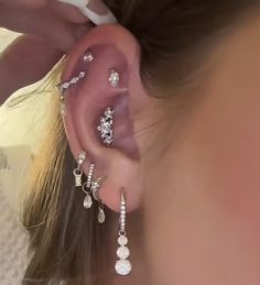 a close up of a person's ear with some jewelry attached to the side