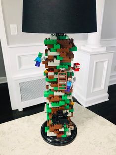 a lamp made out of legos is sitting on a table