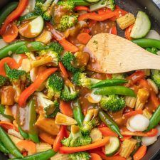 a skillet filled with stir fry vegetables and sauce