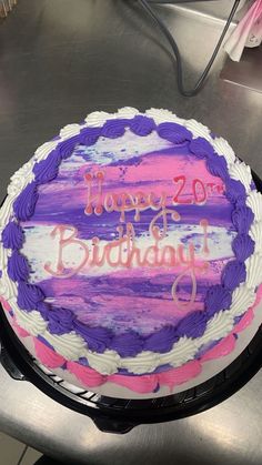 a birthday cake with purple and pink frosting