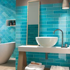 a white sink sitting under a bathroom mirror next to a bath tub and counter top