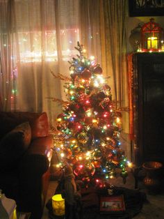 a brightly lit christmas tree in a living room