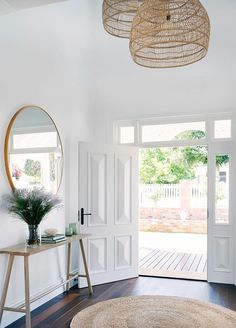 a living room with white walls and wooden floors