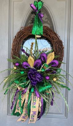 a purple and green wreath on the front door