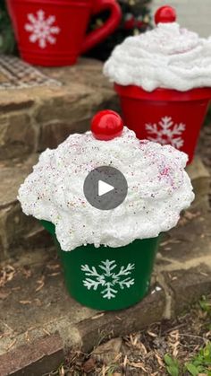 two red and green cups with white frosting on them, one is decorated like a cupcake