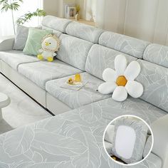 a living room filled with furniture and a white flower on the couch next to it