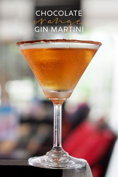 a glass filled with liquid sitting on top of a table