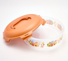 an orange lid on a plastic bowl with floral designs