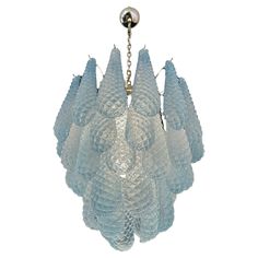 a glass chandelier hanging from a chain