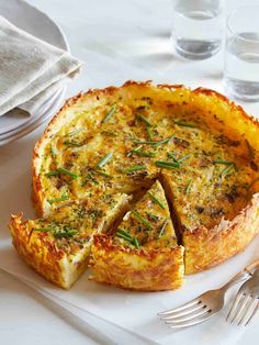 a quiche on a white plate with silverware