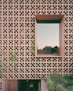 a window in the side of a building that is made out of latticed wood