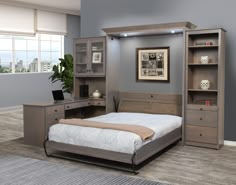 a bedroom with a bed, desk and bookcases in the middle of it