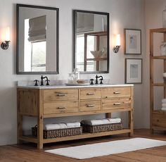 a bathroom with two sinks, mirrors and towels on the shelf in front of the bathtub