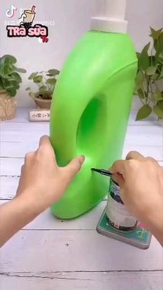 someone is painting the bottom of a green object