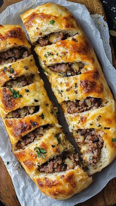 some meat and cheese bread is on a piece of wax paper