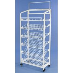 a white rolling cart with four shelves and two wheels on the bottom, against a blue background