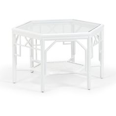 a white side table with a glass top