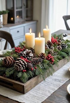 a table with candles and pine cones on it