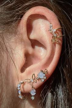 a close up of a person's ear with some piercings on it,