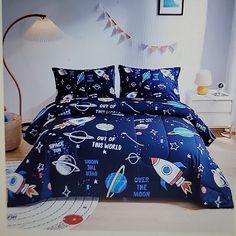 a bed with space themed comforters and pillows