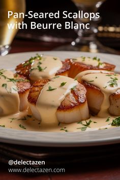 scallops with sauce and parsley on a plate at delectaten