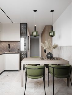 the kitchen is clean and ready to be used for dinner or lunch time, as well as dining table with green chairs