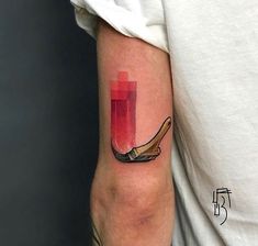 a man's arm with a red candle and shoe tattoo on the left forearm